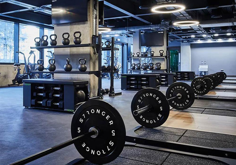 Gym interior with free weights, Olympic barbells and Heavy Duty Gym Flooring