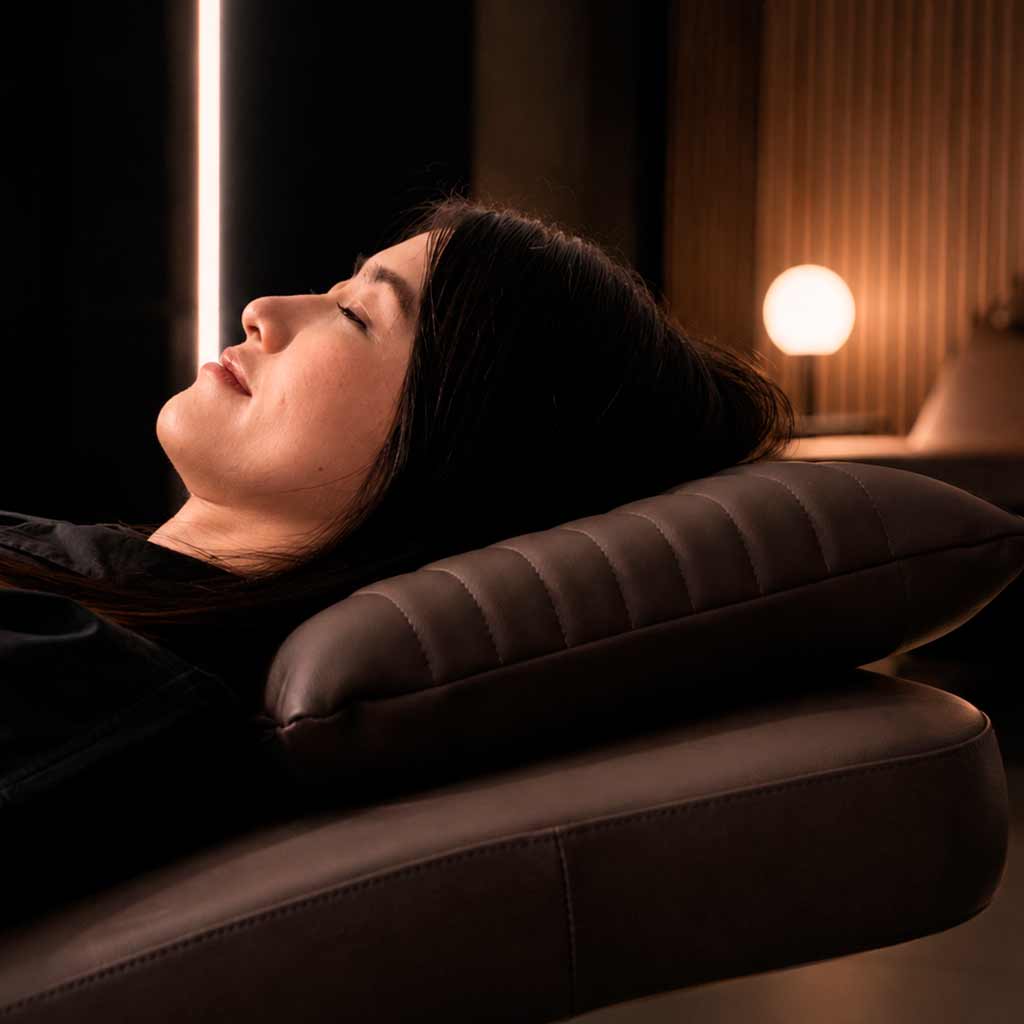 Woman receiving a massage in a neurosonic recovery room. 